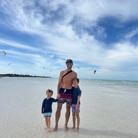 A dad and his two boys enjoying a day at the beach